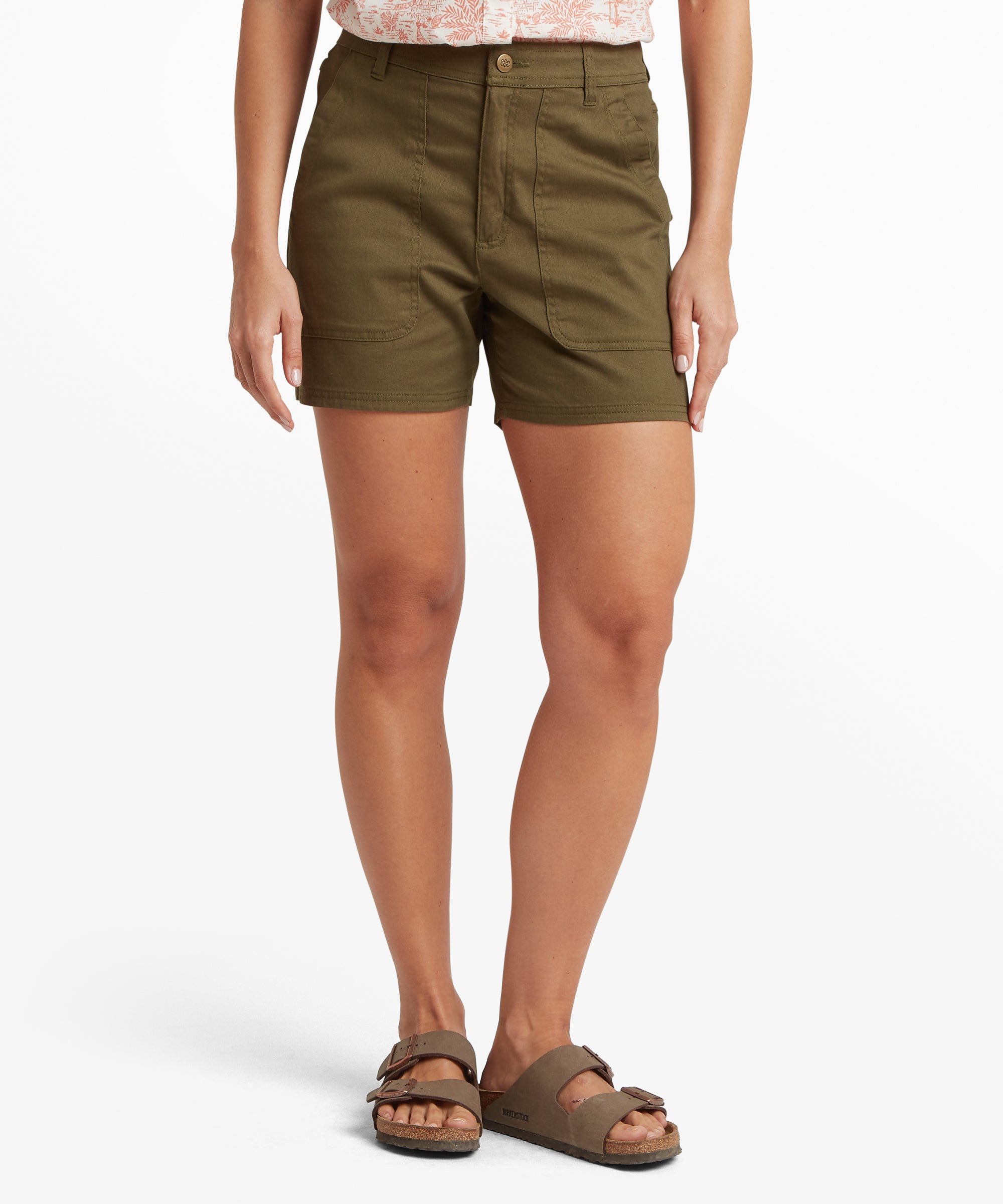 Front view of olive green casual shorts with a mid-rise waist, button closure, belt loops, and large front patch pockets, worn with slip‑on sandals on a white studio background.