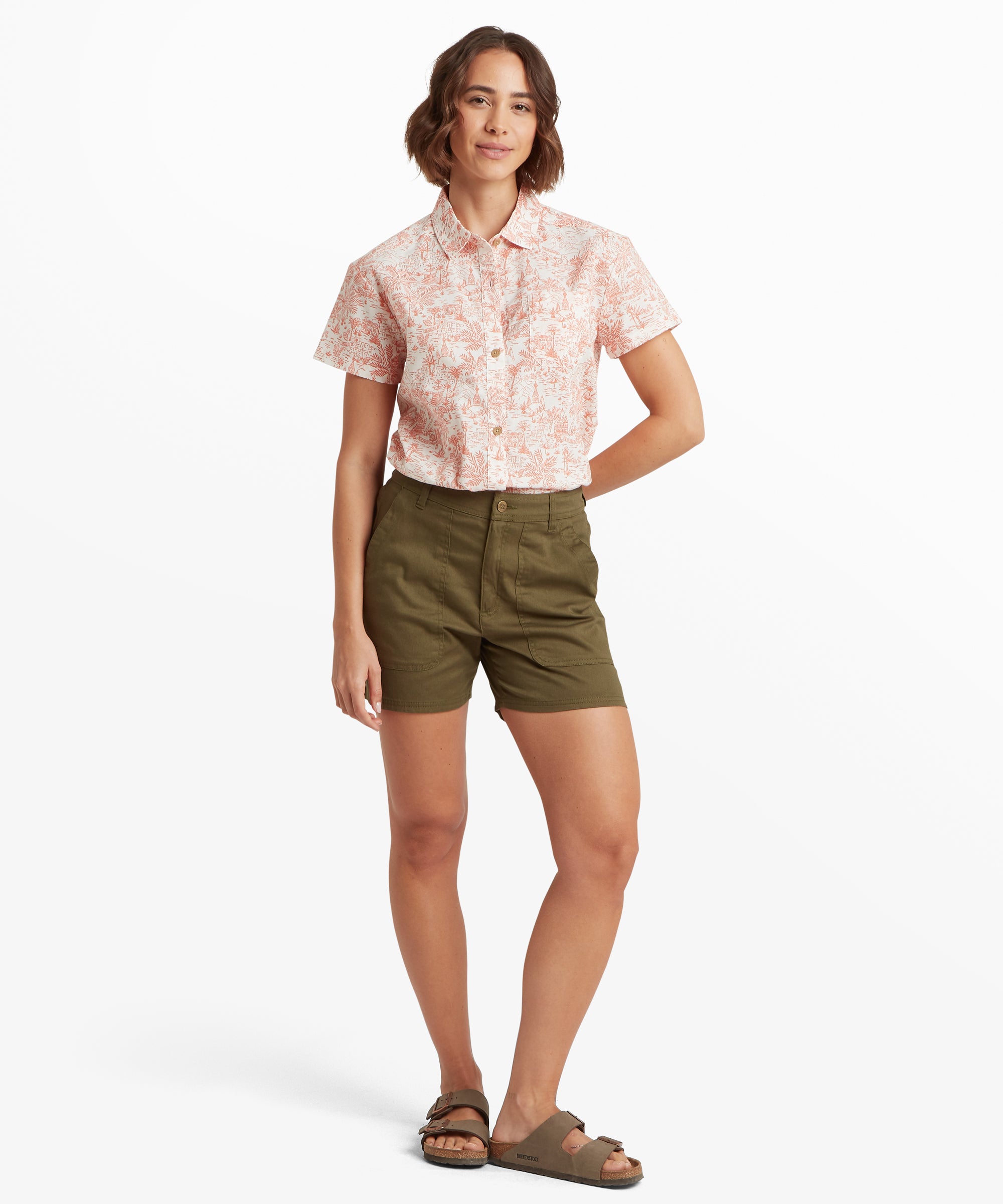Full‑body outfit showing olive green shorts paired with a short‑sleeve patterned shirt and brown sandals, photographed against a clean white background.