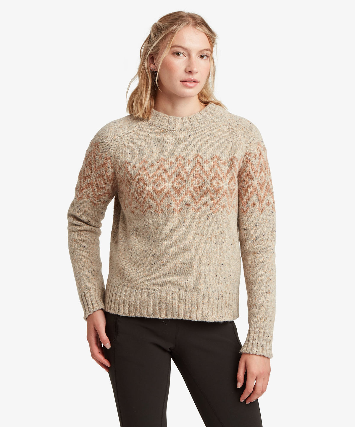 Woman wearing Sherpa Adventure Gear Dumji Sweater in white and beige.