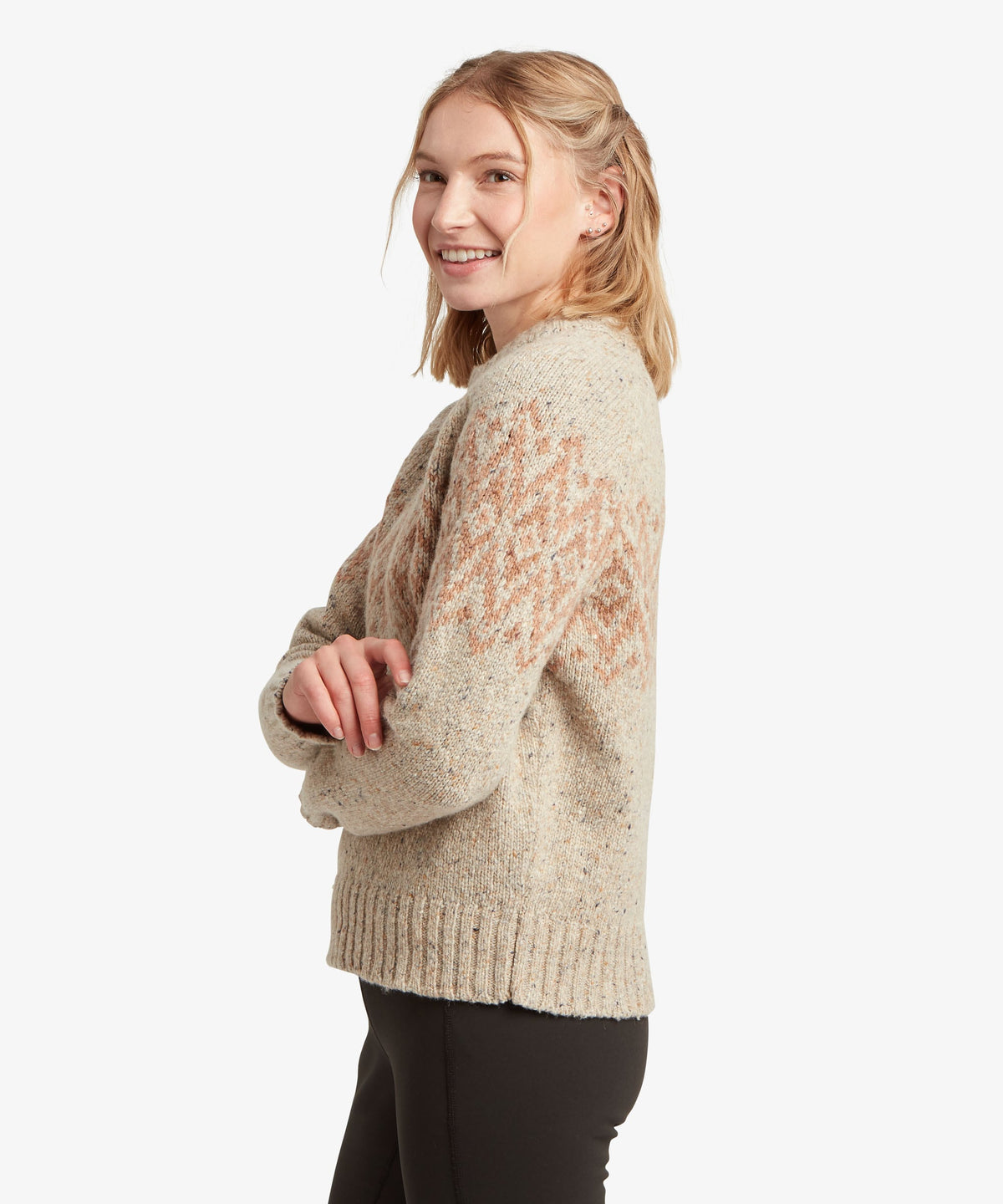 Side view of woman wearing Sherpa Adventure Gear Dumji Sweater in white and beige.