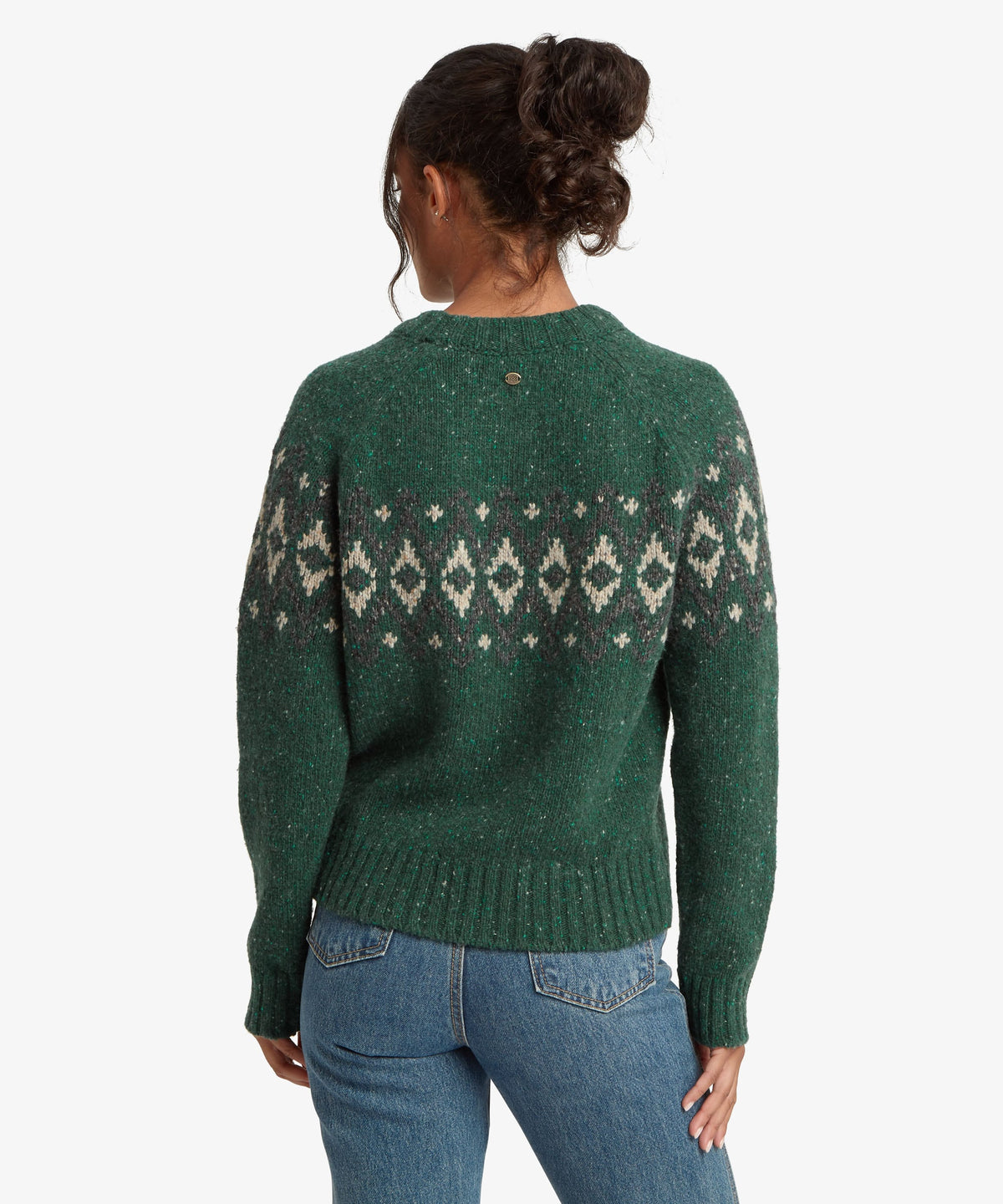 Rear view of woman wearing Sherpa Adventure Gear Dumji Sweater in green.