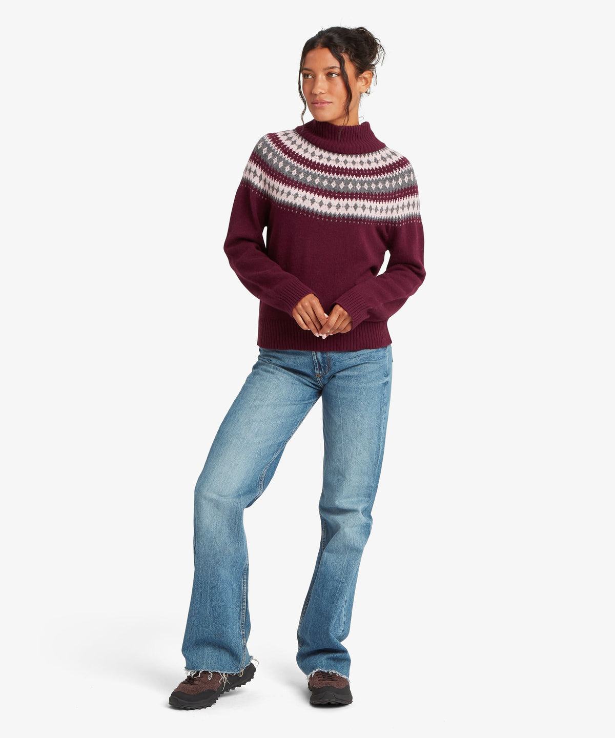 Front view of woman wearing Sherpa Adventure Gear women's Indu Mock Neck sweater in purple.
