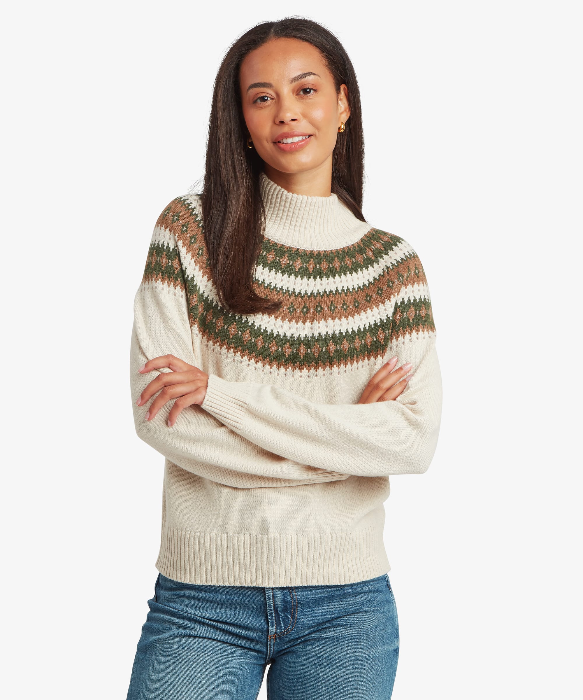 Woman wearing a cream-white mock neck sweater featuring green, brown, and mustard Fair Isle-inspired stripes across the chest and shoulders. Front view showing the fitted neckline, long sleeves, and soft knit construction.