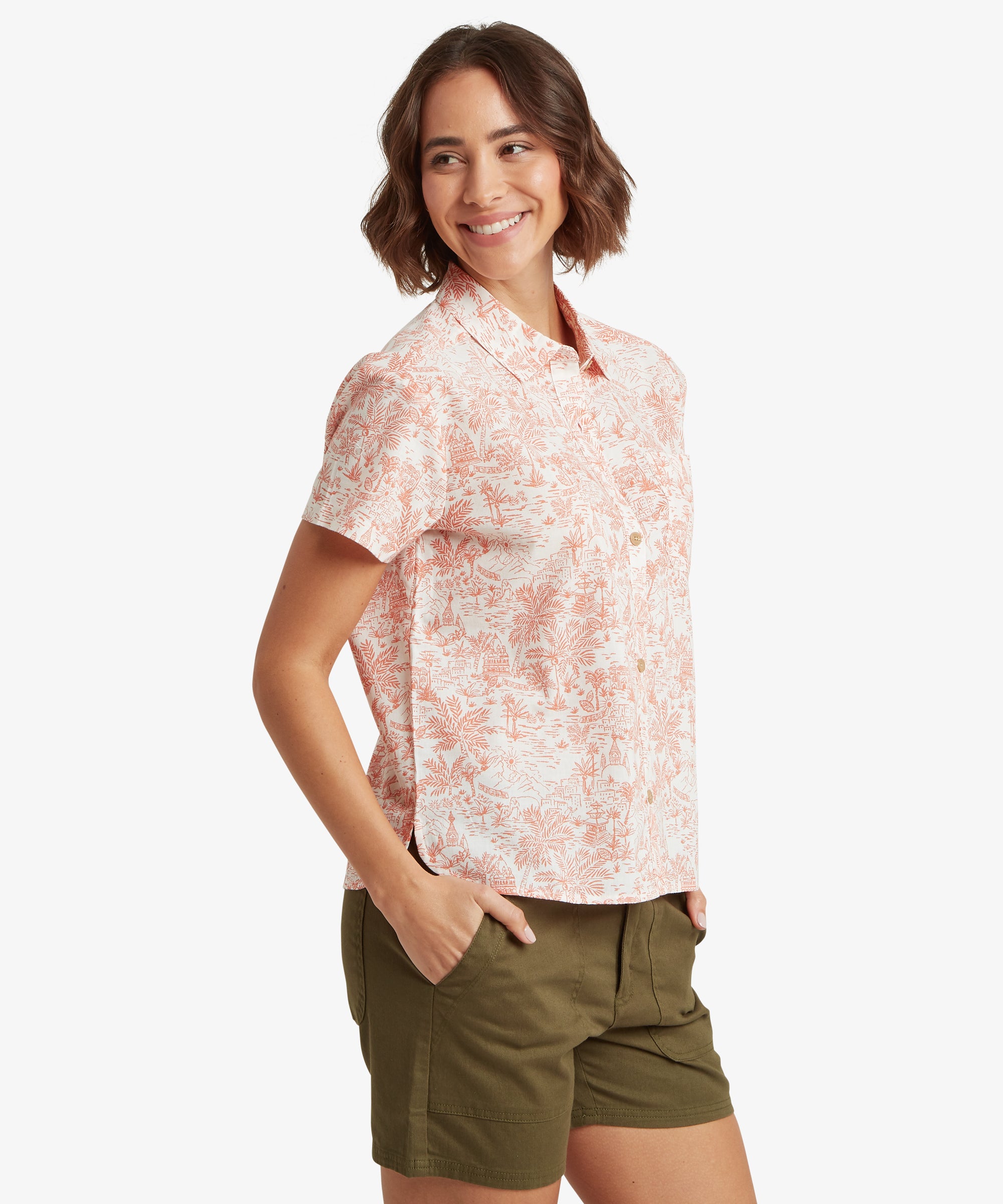 A side-profile view of a woman wearing the button-up shirt, showcasing the clean drape of the fabric. The sleeves have a modest, relaxed cut, and the straight hemline provides a comfortable fit that allows for easy movement.