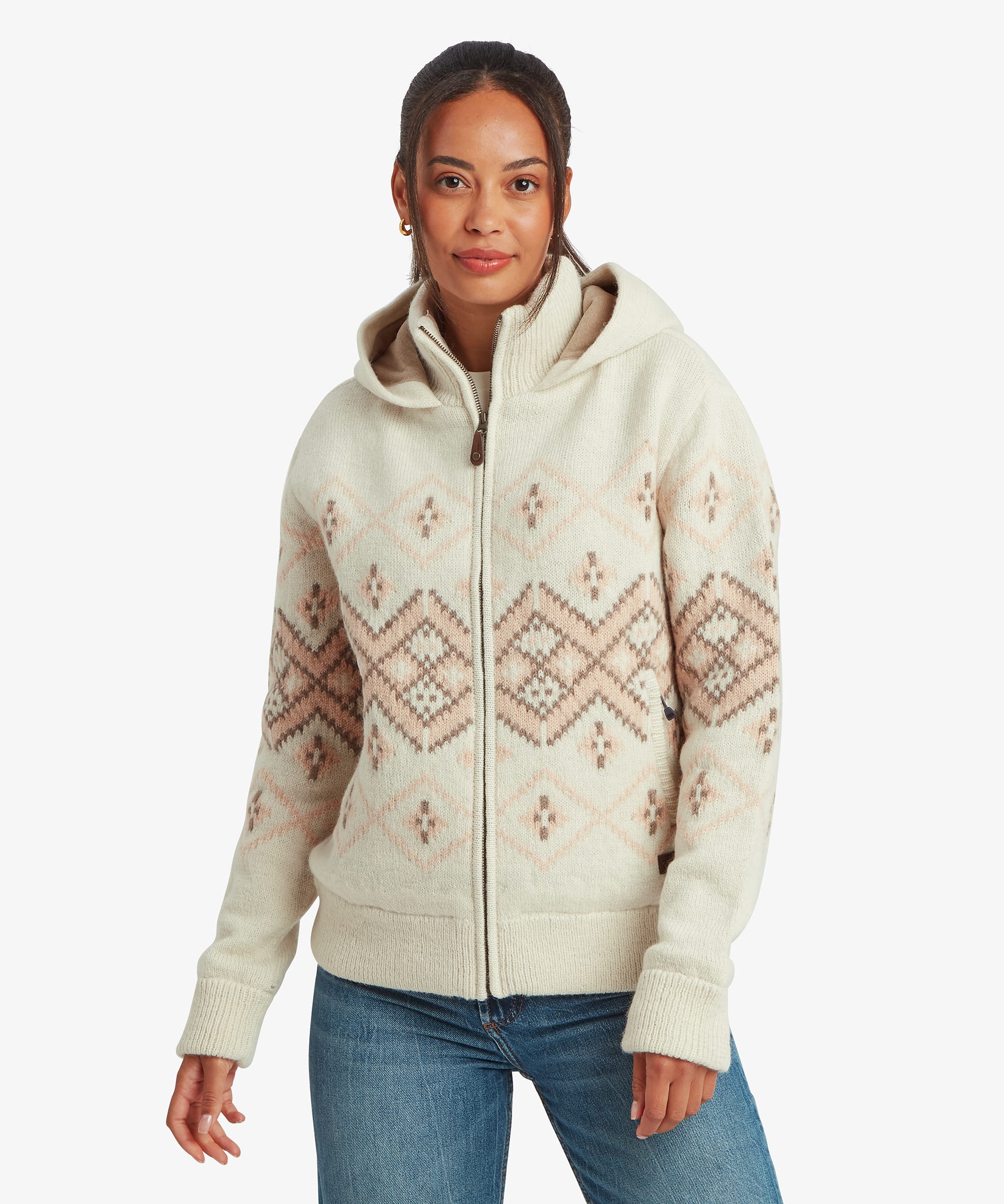 Woman wearing a cream full-zip sweater jacket with a cozy hood and soft geometric Fair Isle-inspired pattern throughout the body and sleeves. Front view highlighting the zip closure, ribbed cuffs, and relaxed fit.