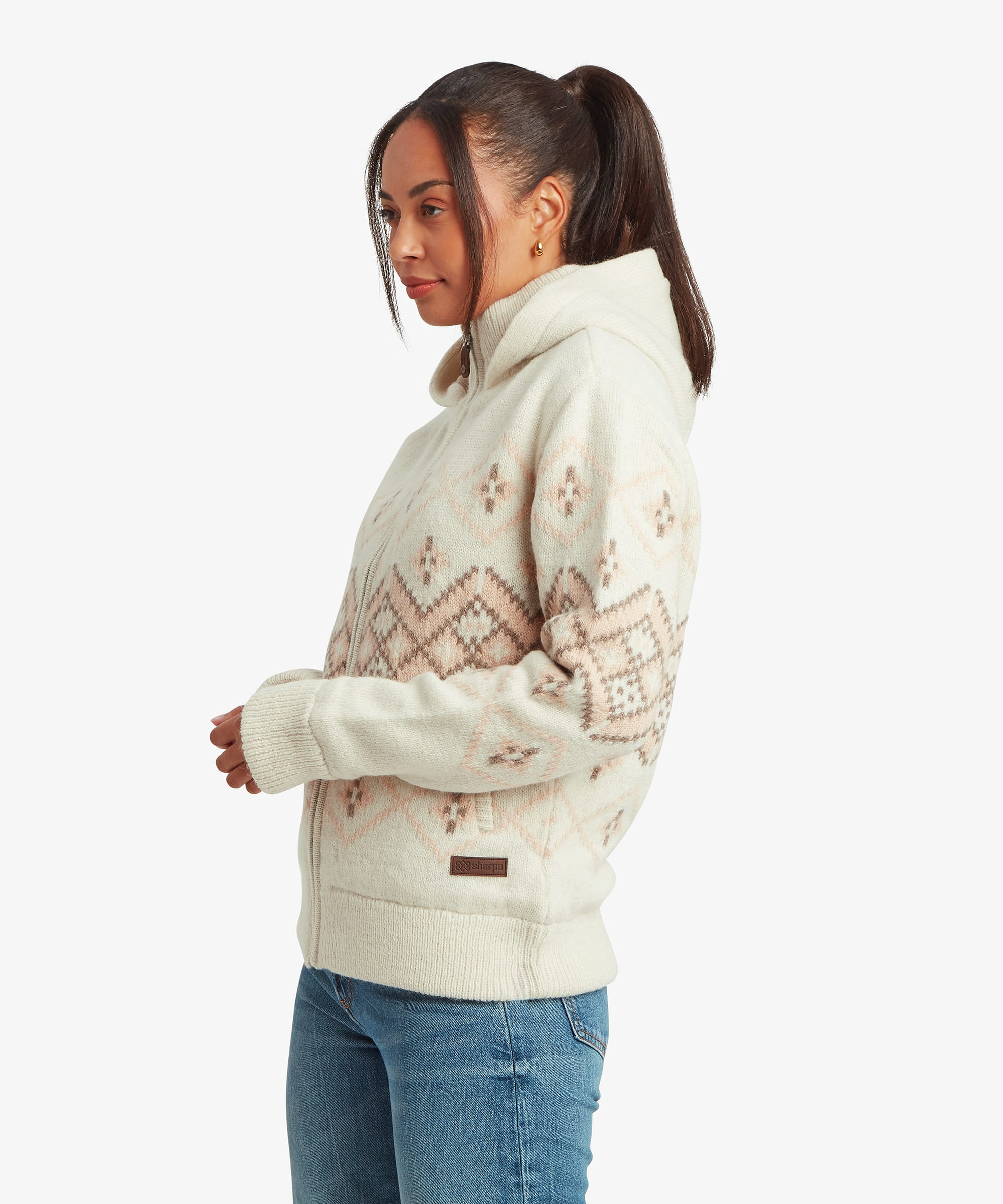 Side view of the women's Kirtipur sweater in white showcasing the quarter-zip collar and Fair Isle inspired geometric knit pattern across the body and sleeves.