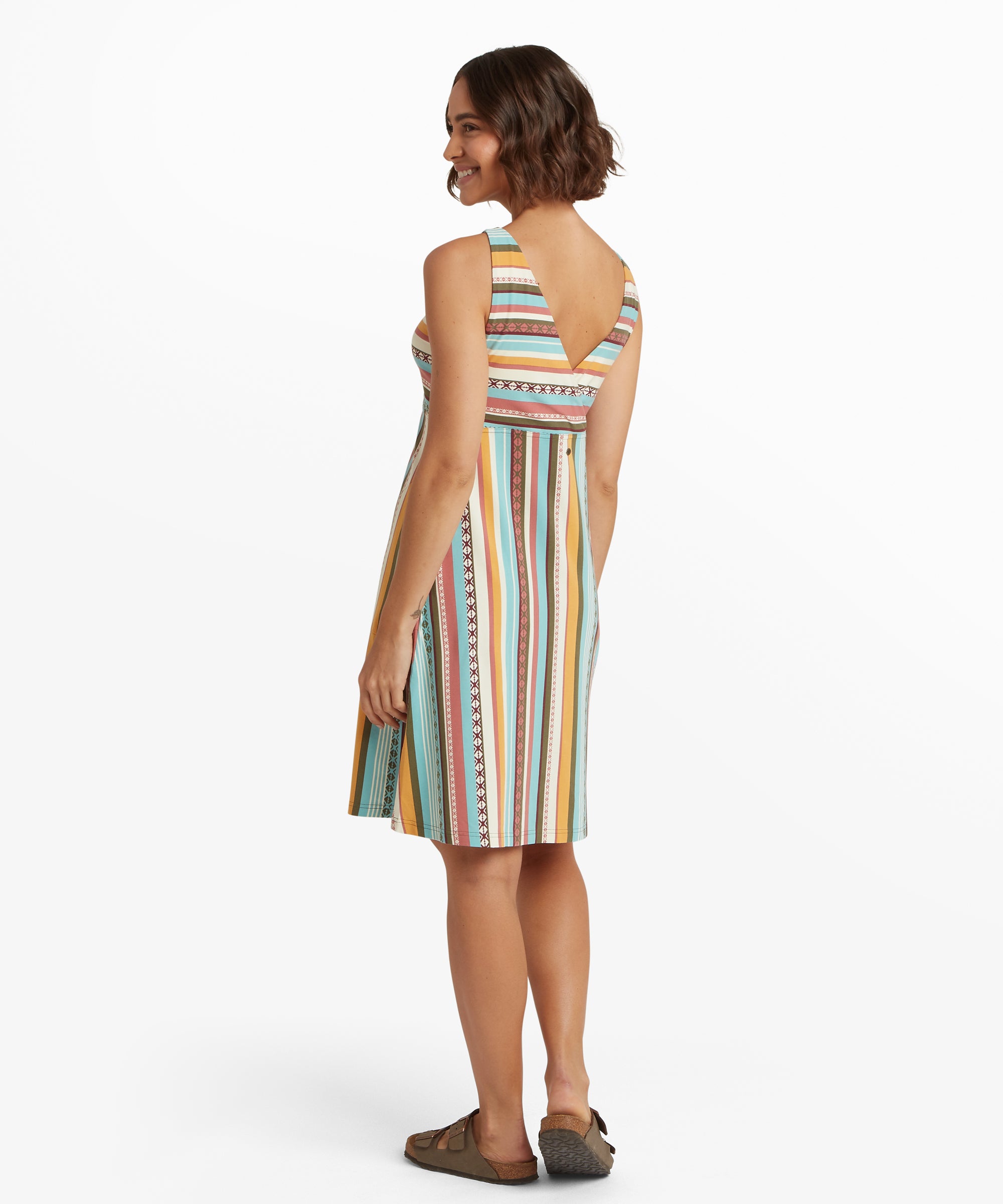 Back view of a sleeveless empire-waist dress featuring colourful vertical stripes and a deep V-shaped back neckline.
