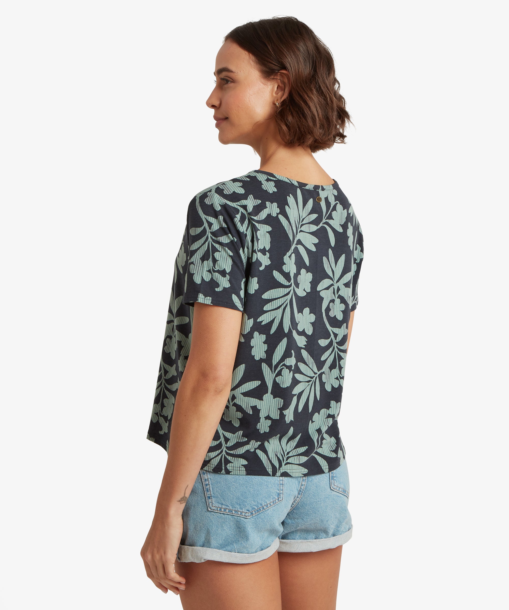 RŸckansicht eines marineblauen T-Shirts mit Blumenprint, kombiniert mit hellblauen Jeansshorts mit umgeschlagenen SŠumen, die die lockere Silhouette des Shirts betonen.