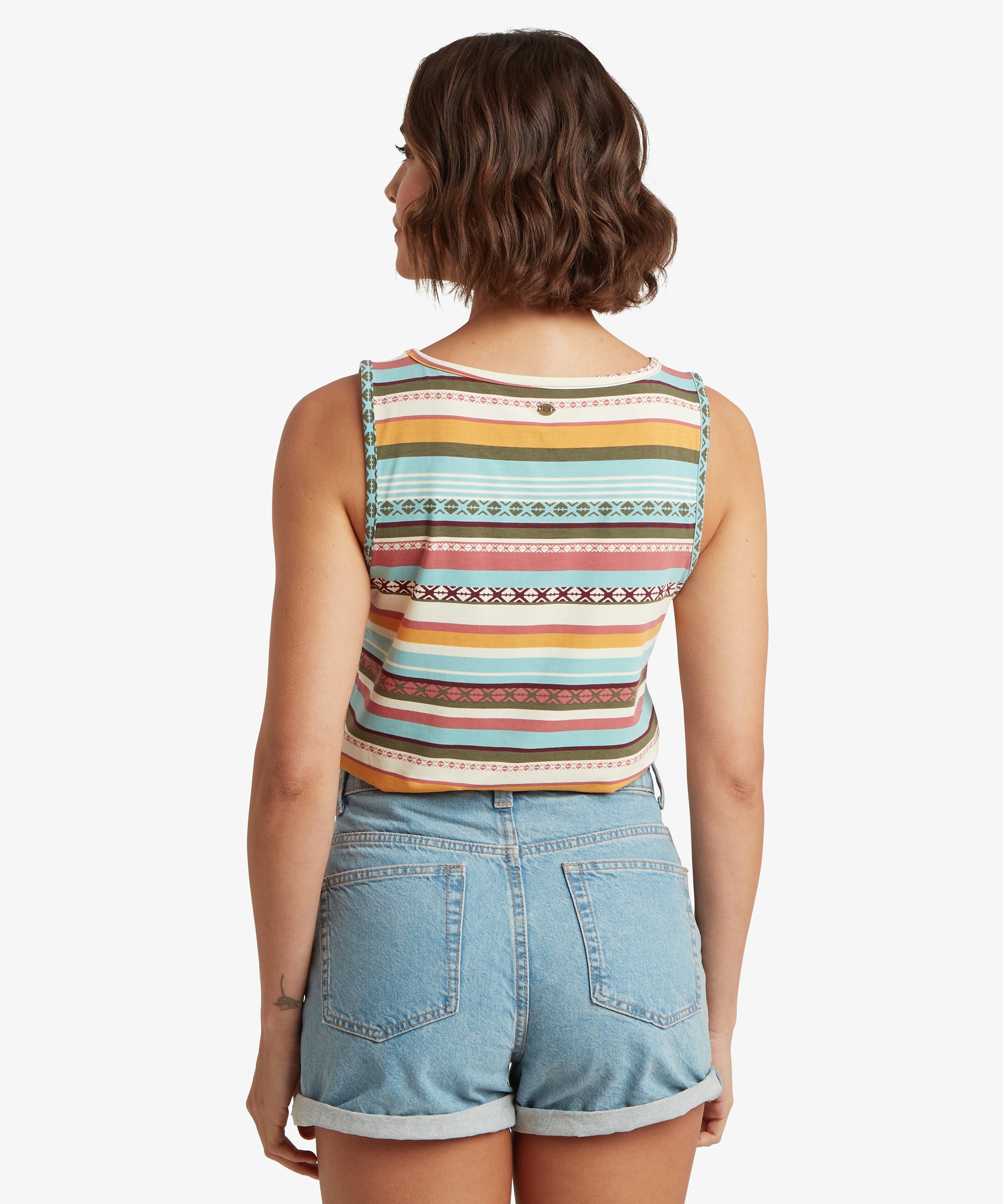 Rear view of a striped V‑neck tank top with colourful horizontal patterns paired with rolled‑hem denim shorts.