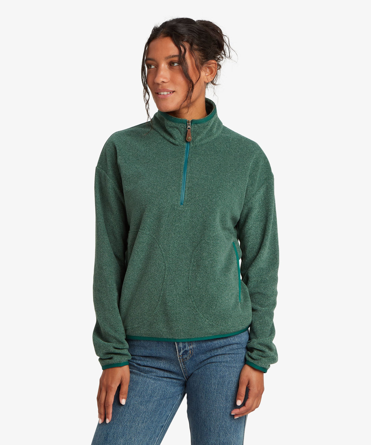 Front view of woman wearing Sherpa Adventure Gear women's Rolpa 1/2 Zip in green.