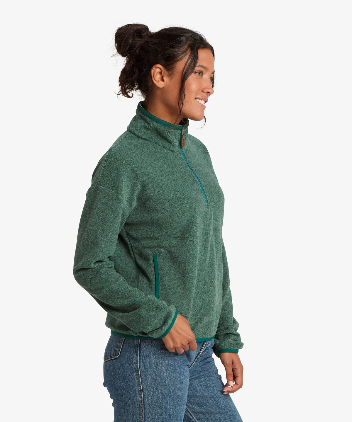 A female model wearing the Sherpa Adventure Gear womenÕs Rolpa 1/2 Zip in green.