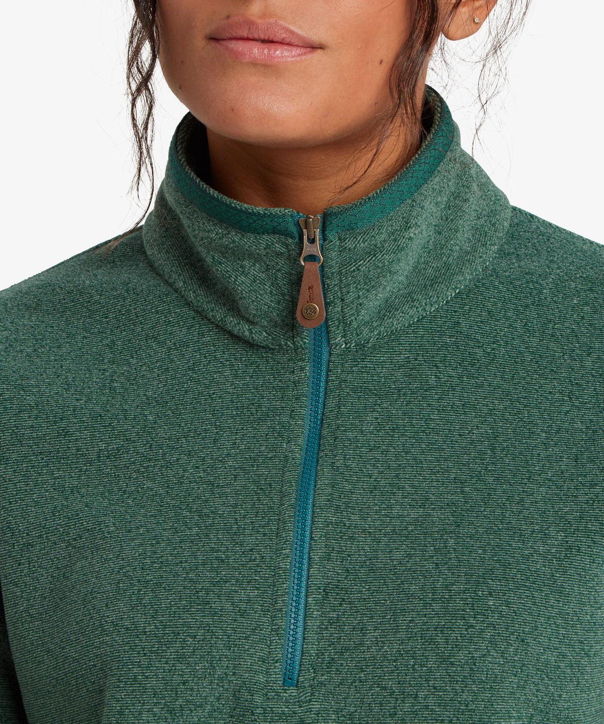 A female model wearing the Sherpa Adventure Gear womenÕs Rolpa 1/2 Zip in green.