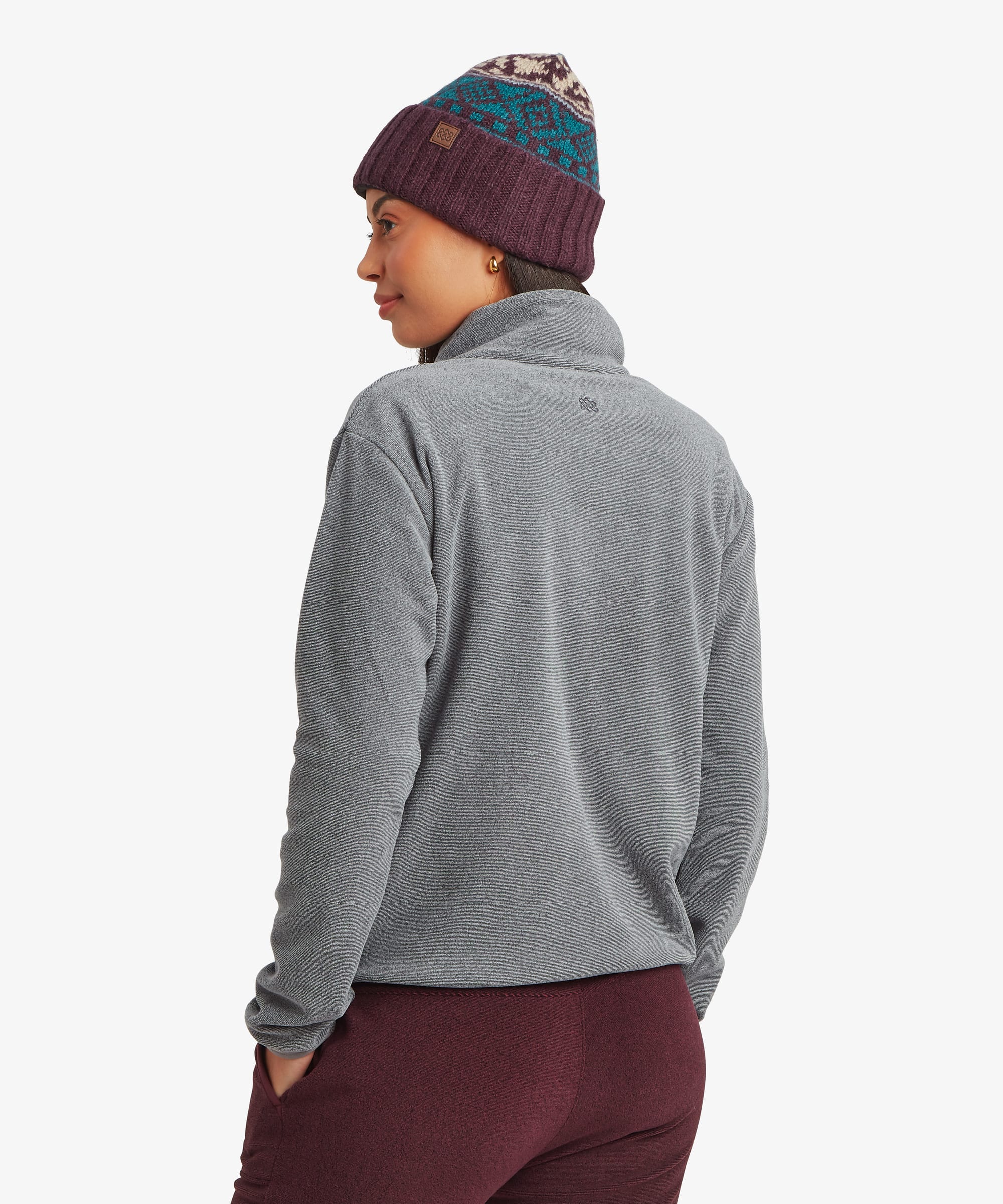 Rear view of a woman wearing the Sherpa Rolpa Full-Zip Fleece Jacket in grey. The image highlights the clean back design and soft fleece construction.