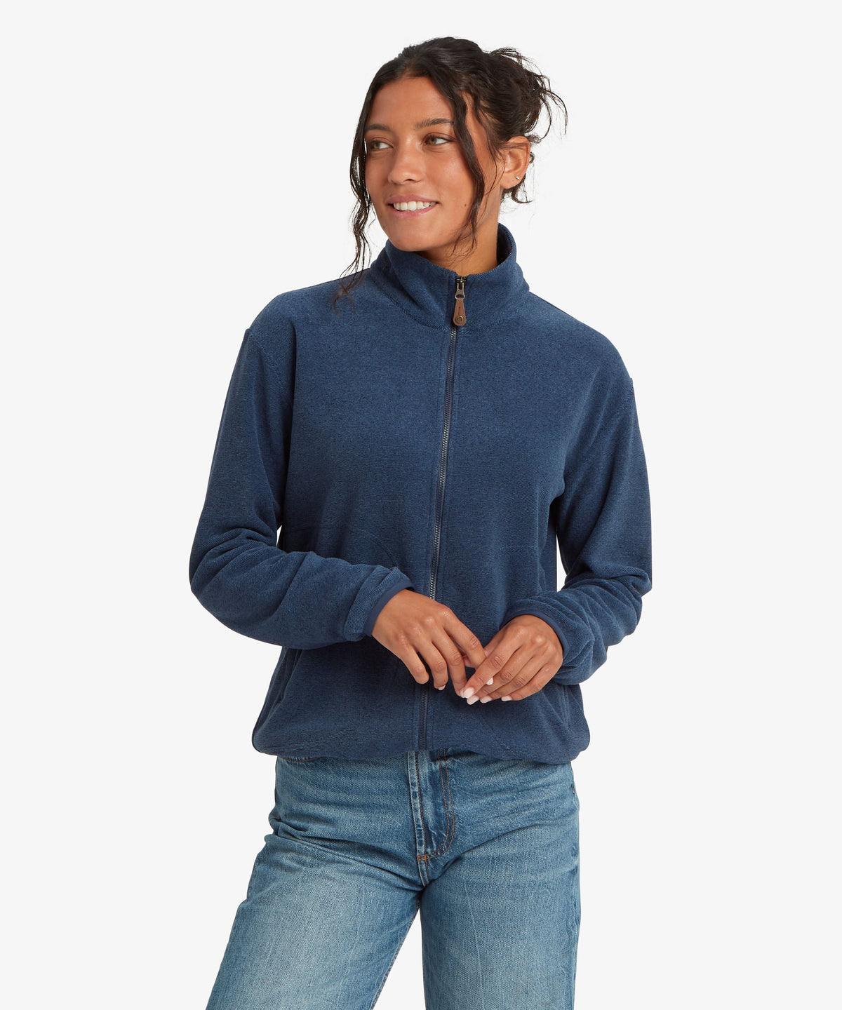 A female model wearing the Sherpa Adventure Gear Rolpa Full Zip fleece in navy.