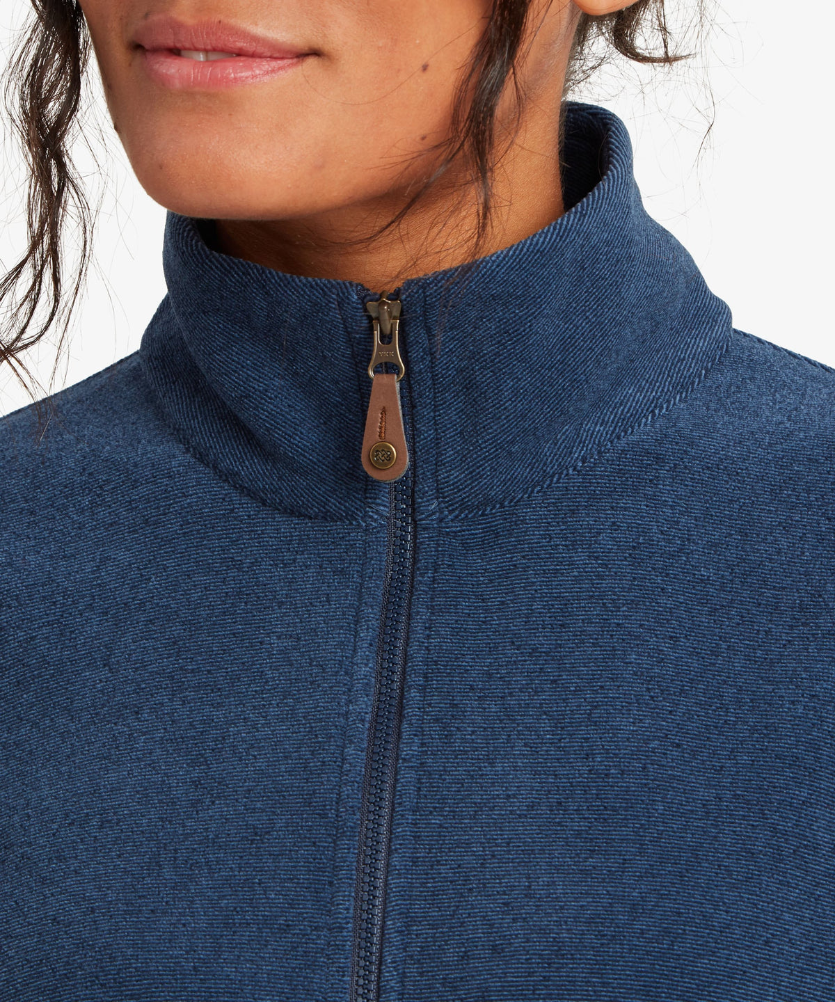 A female model wearing the Sherpa Adventure Gear Rolpa Full Zip fleece in navy.