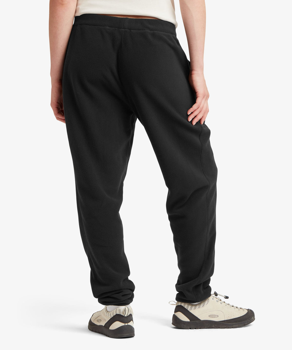 A female model wearing the Sherpa Adventure Gear black Rolpa Jogger trousers.