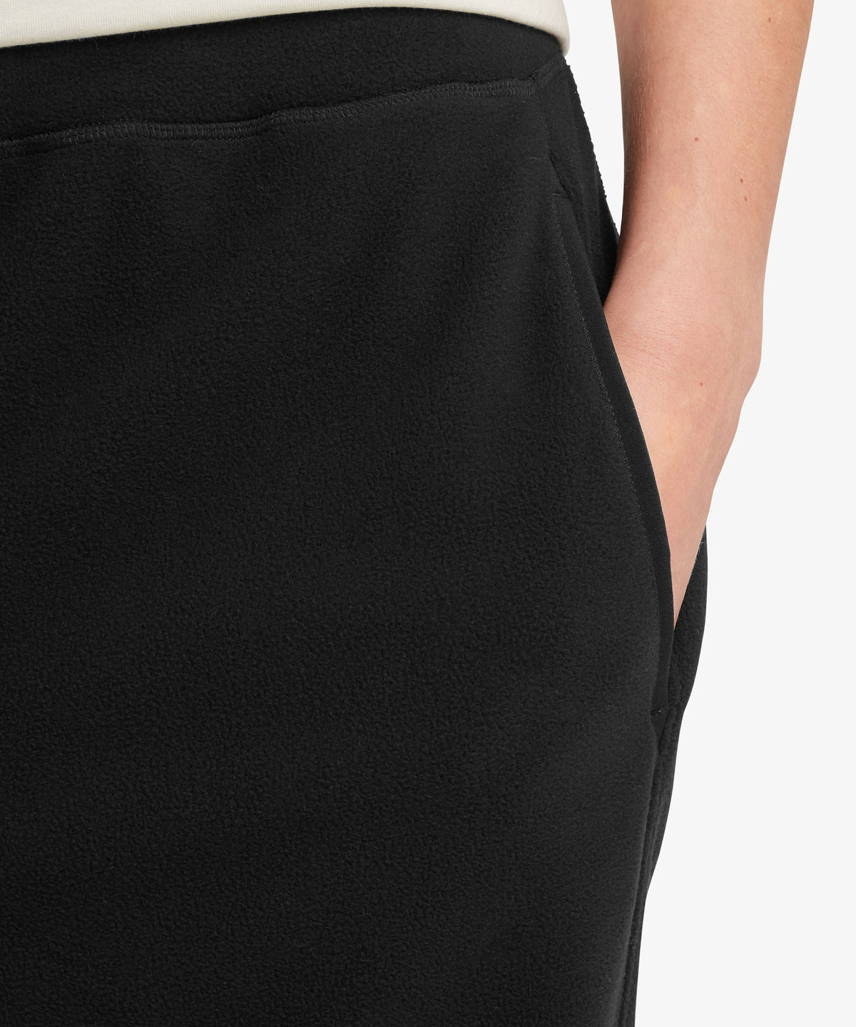 A female model wearing the Sherpa Adventure Gear black Rolpa Jogger trousers, shown in close-up.