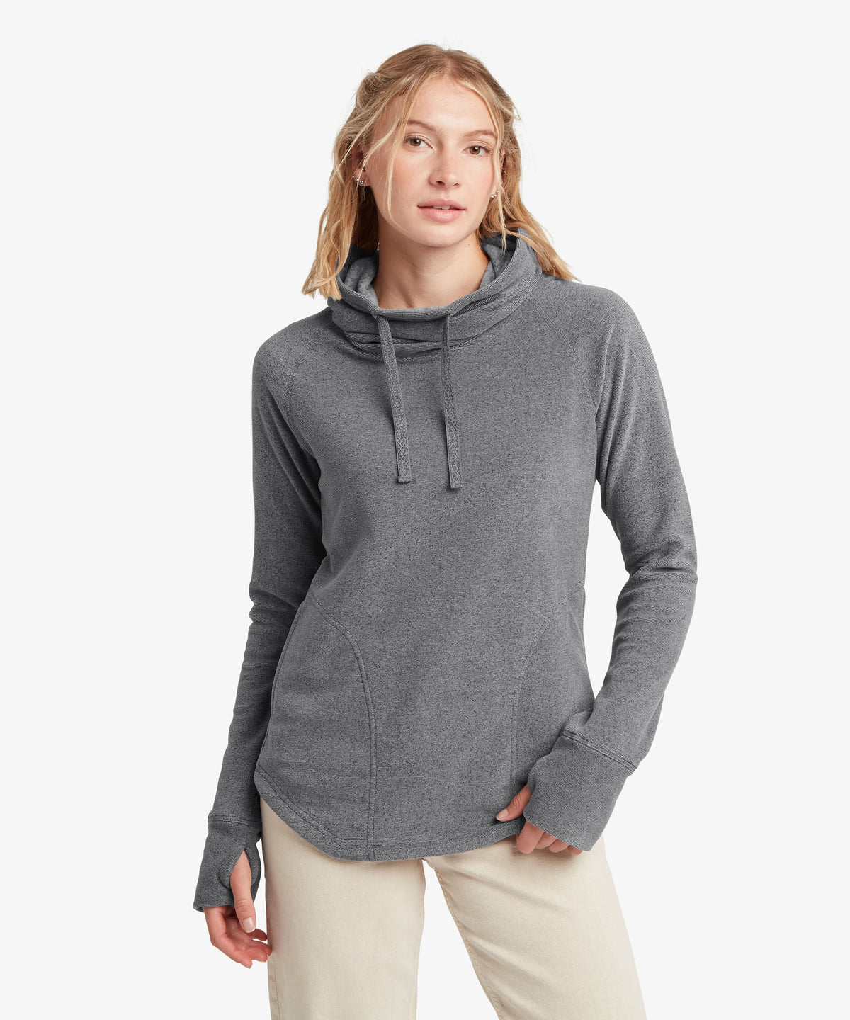A female model wearing the Sherpa Adventure Gear grey Rolpa Pullover with cream trousers.
