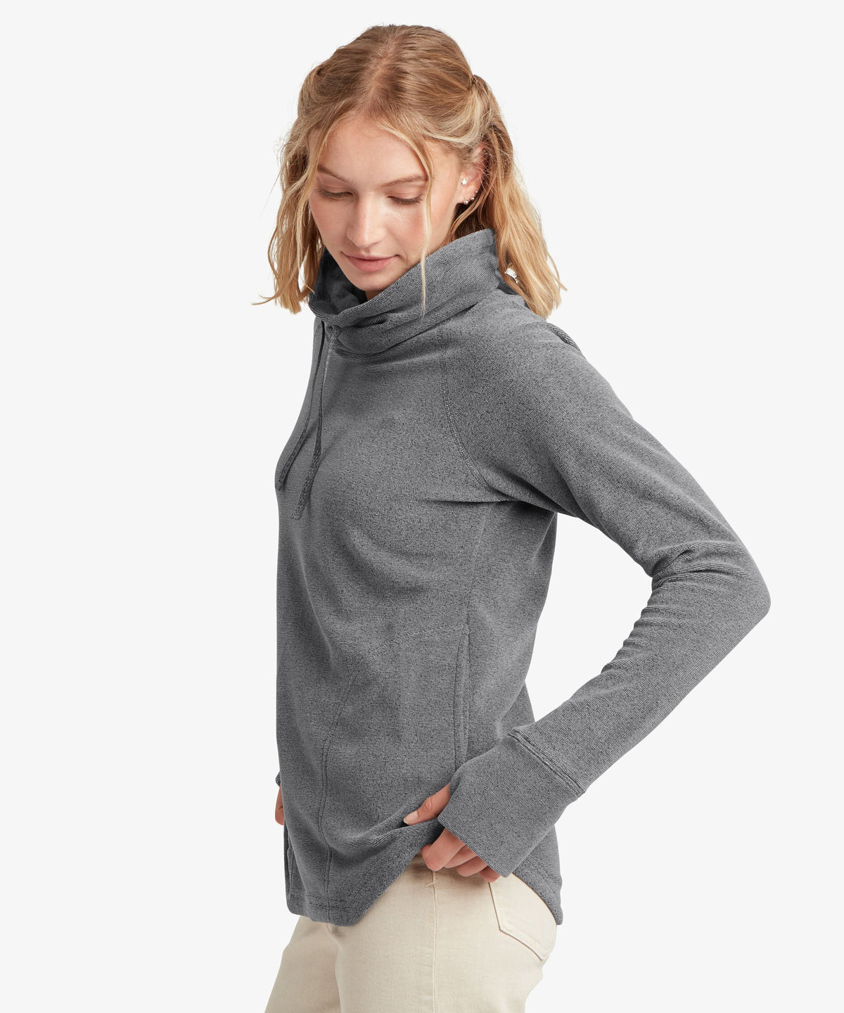 A female model wearing the Sherpa Adventure Gear grey Rolpa Pullover.