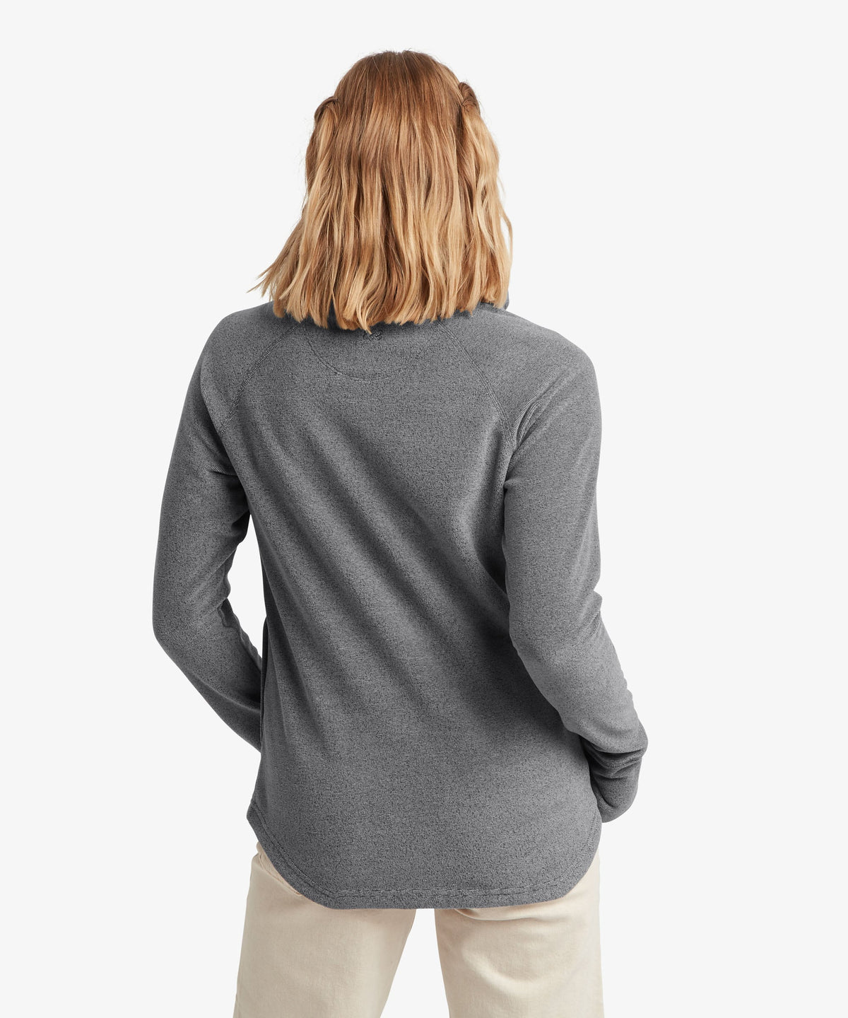A female model wearing the Sherpa Adventure Gear grey Rolpa Pullover.