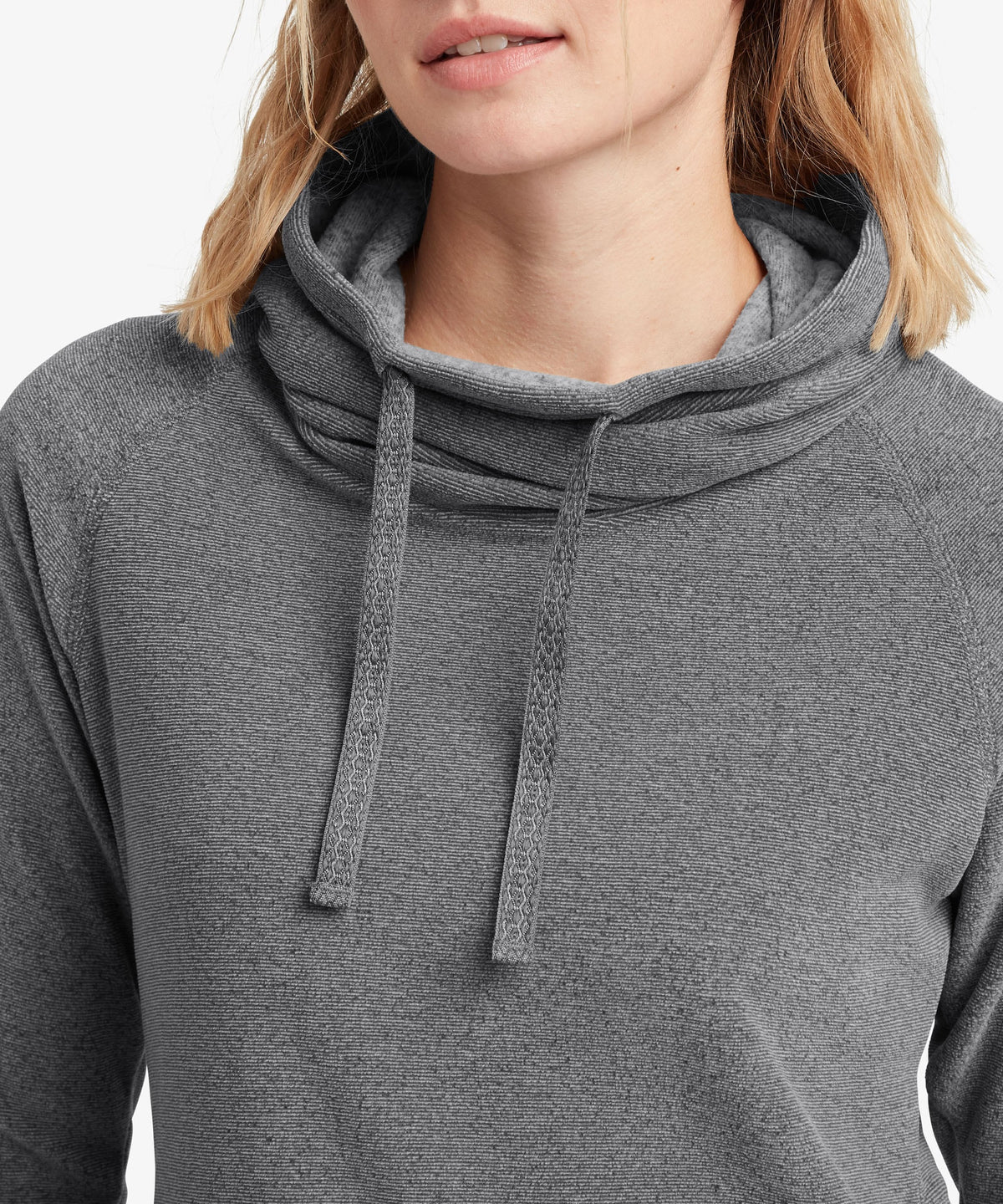 A female model wearing the Sherpa Adventure Gear grey Rolpa Pullover, shown in close-up.