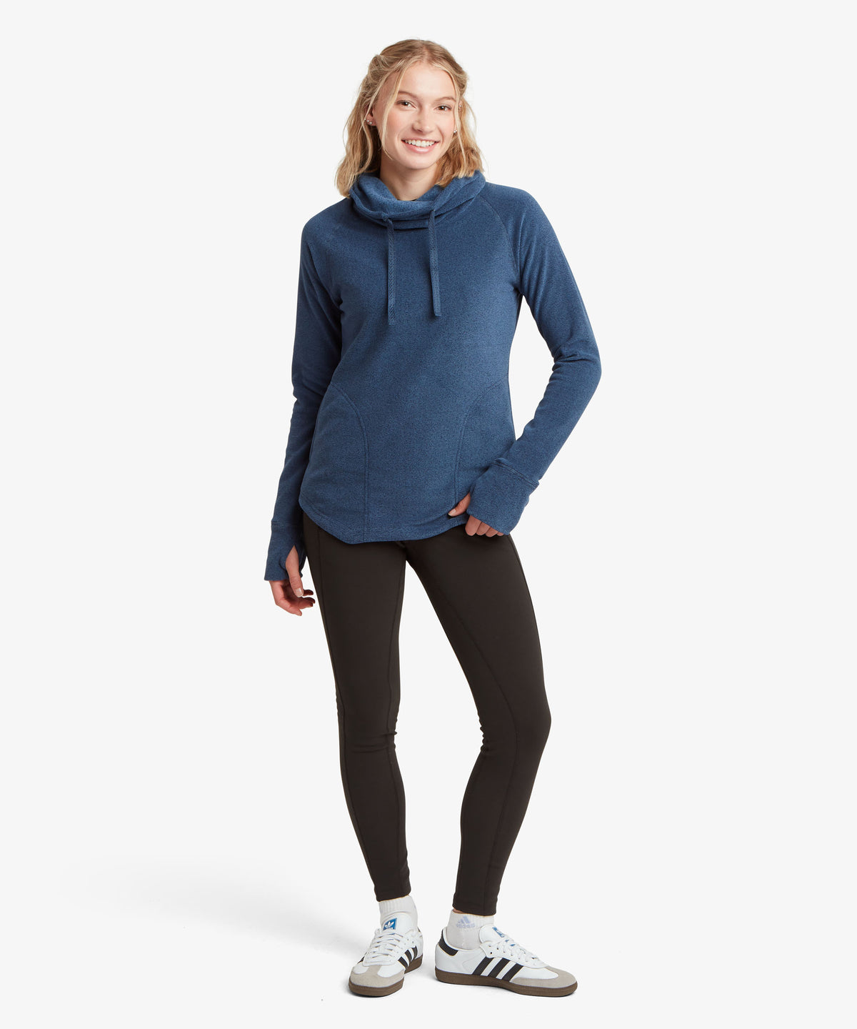 Woman modeling navy funnel-neck pullover with black leggings, full-body front view