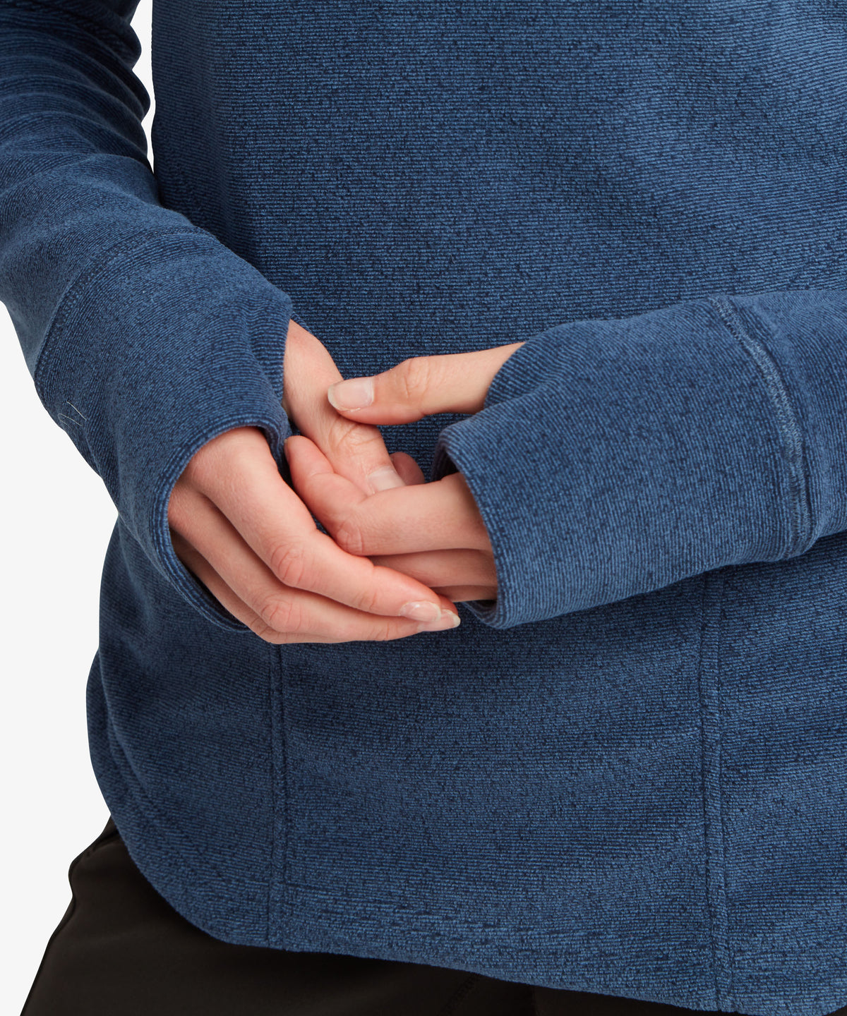 Close of of a woman's hands wearing navy fleece with thumb loops