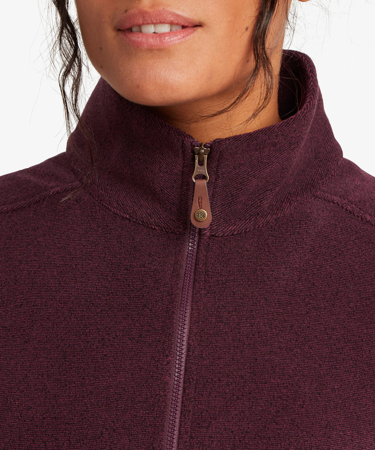 A female model wearing the Sherpa Adventure Gear purple Rolpa Vest, shown in close-up.