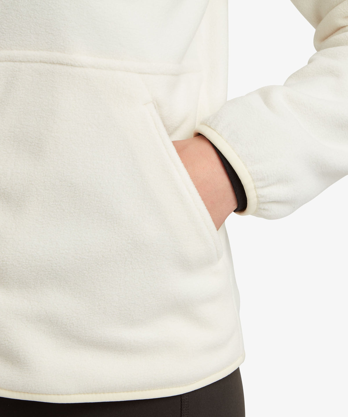 A female model wearing the Sherpa Adventure Gear white Sanu Full-Zip fleece, shown in close-up.