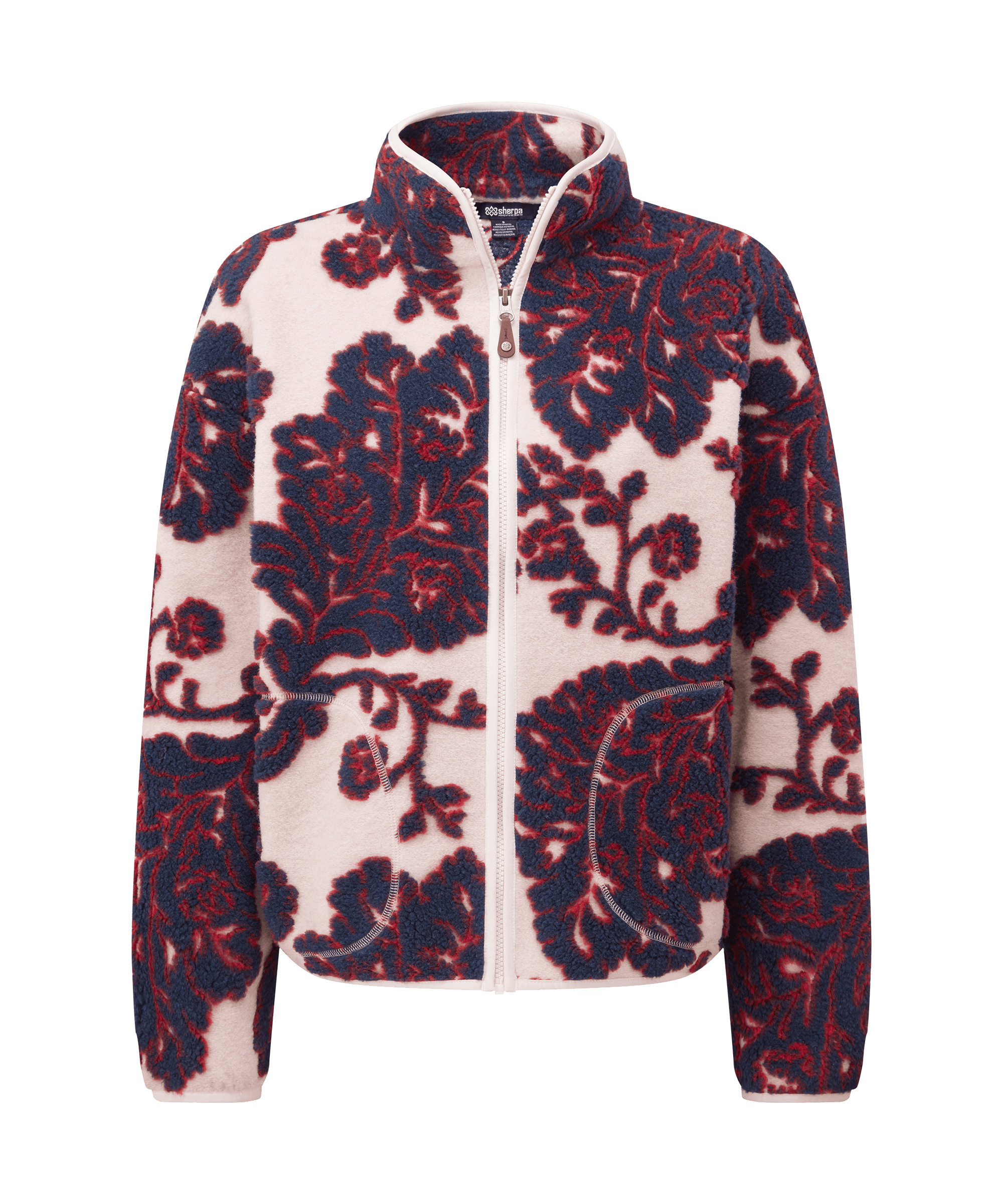 Front view of a women's Sherpa Adventure Gear full-zip fleece jacket in cream white with deep red floral artwork. Features a stand collar, full-front zipper, zippered pockets, and an allover patterned design inspired by traditional textile motifs.