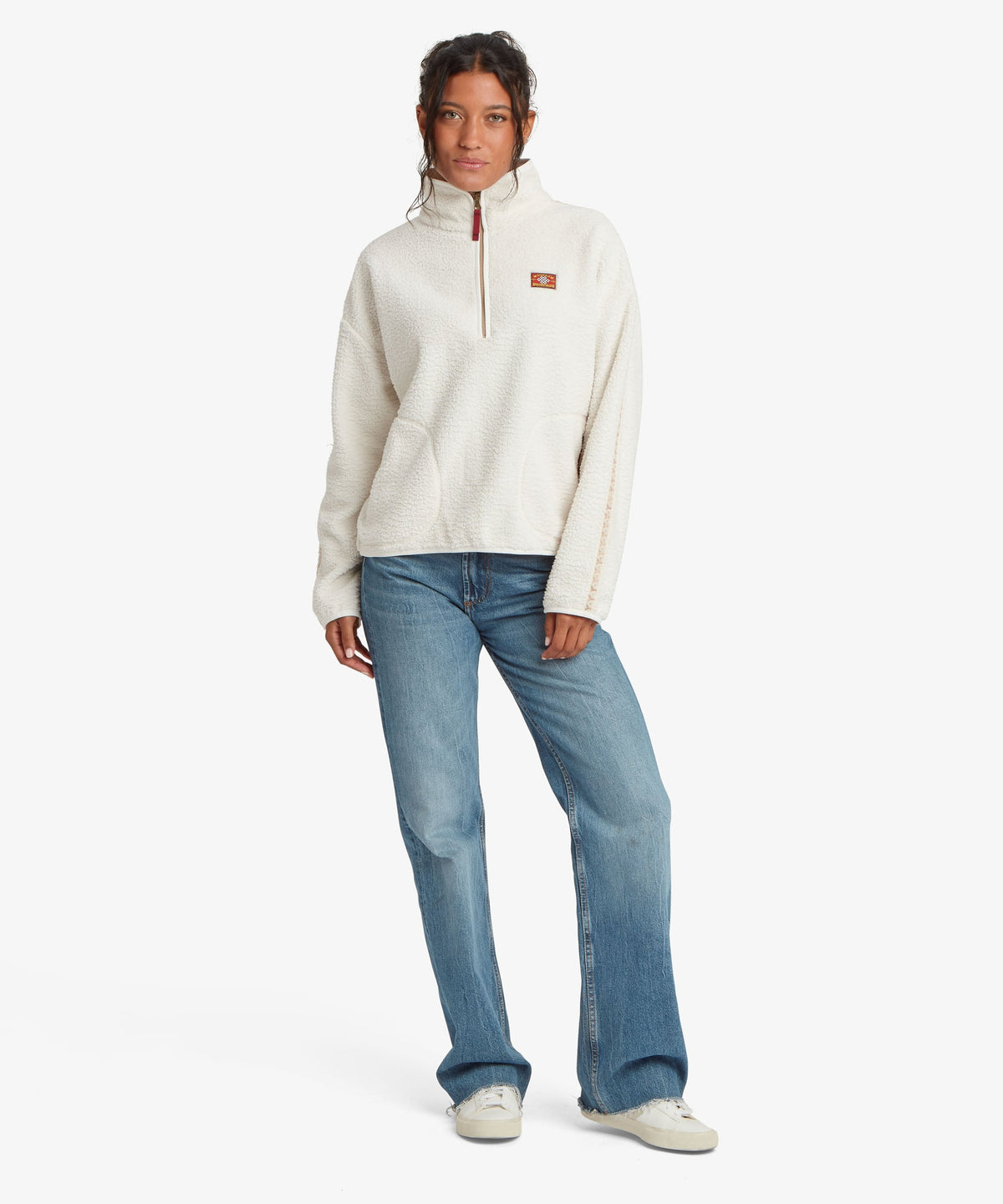 Front view of woman wearing Sherpa Adventure Gear women's Tarcho 1/4-zip fleece pullover in white.