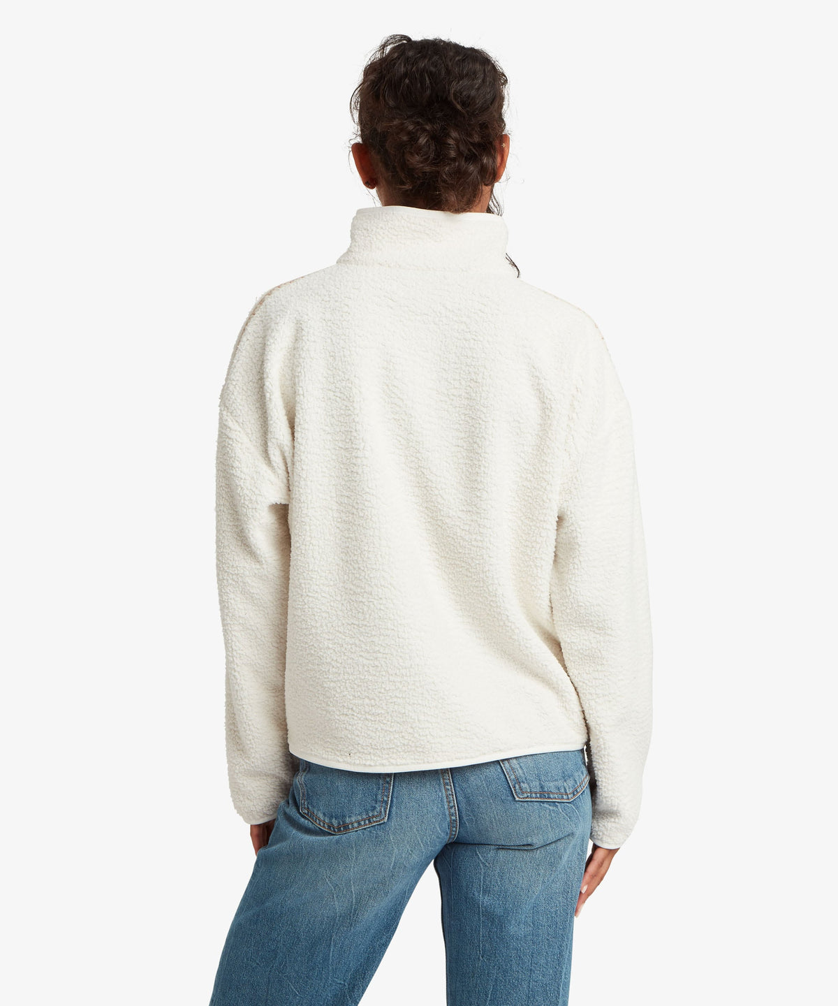 Back view of woman wearing Sherpa Adventure Gear women's Tarcho 1/4-zip fleece pullover in white.
