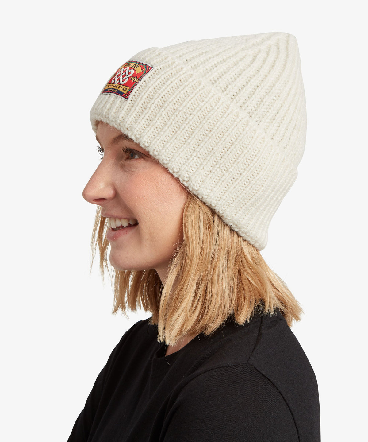 A woman in profile wearing a ribbed knit beanie hat.