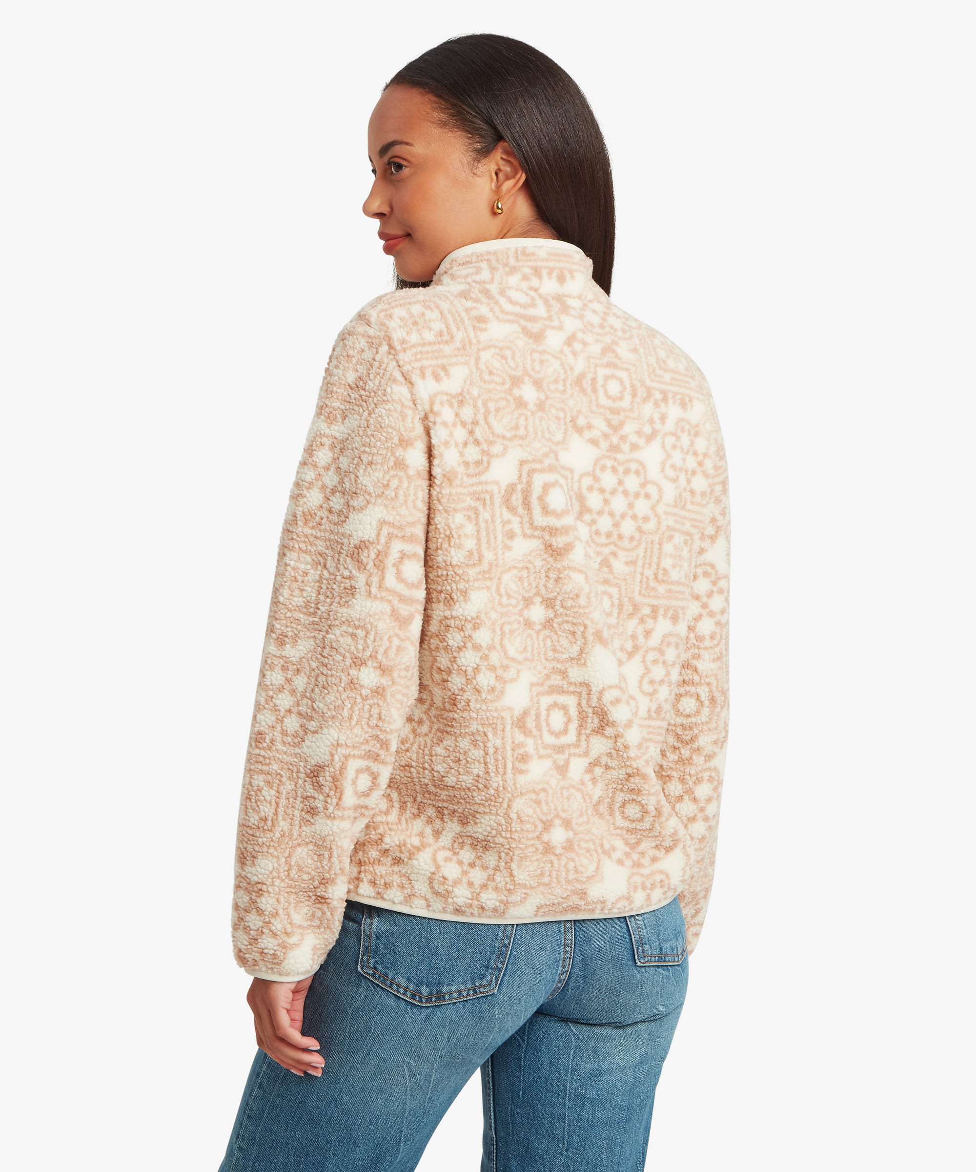 Back view of a woman wearing a cream printed fleece jacket featuring a subtle all-over geometric design. The image showcases the pattern coverage across the back and sleeves.