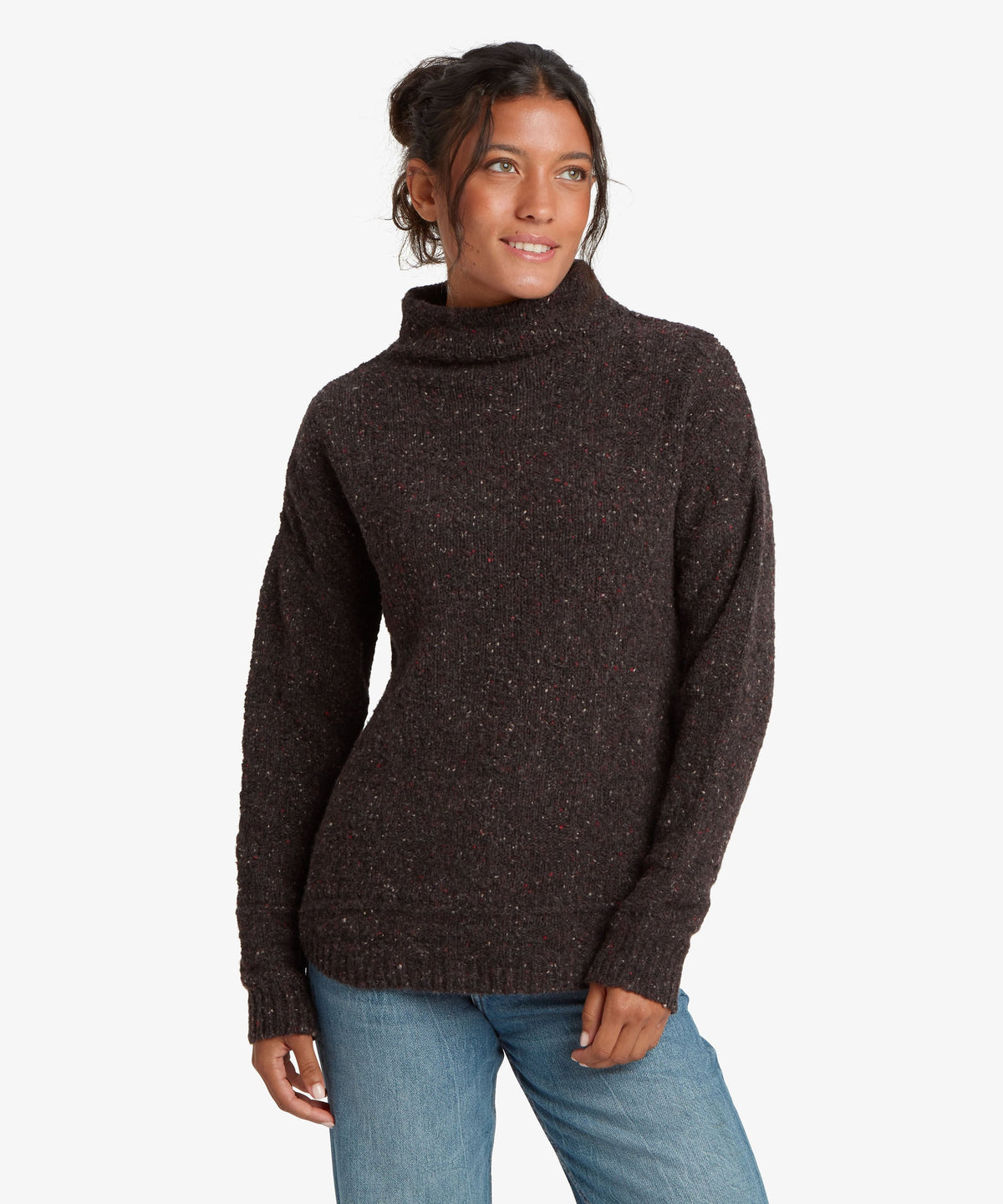 A female model wearing the black Yuden Sweater by Sherpa Adventure Gear.