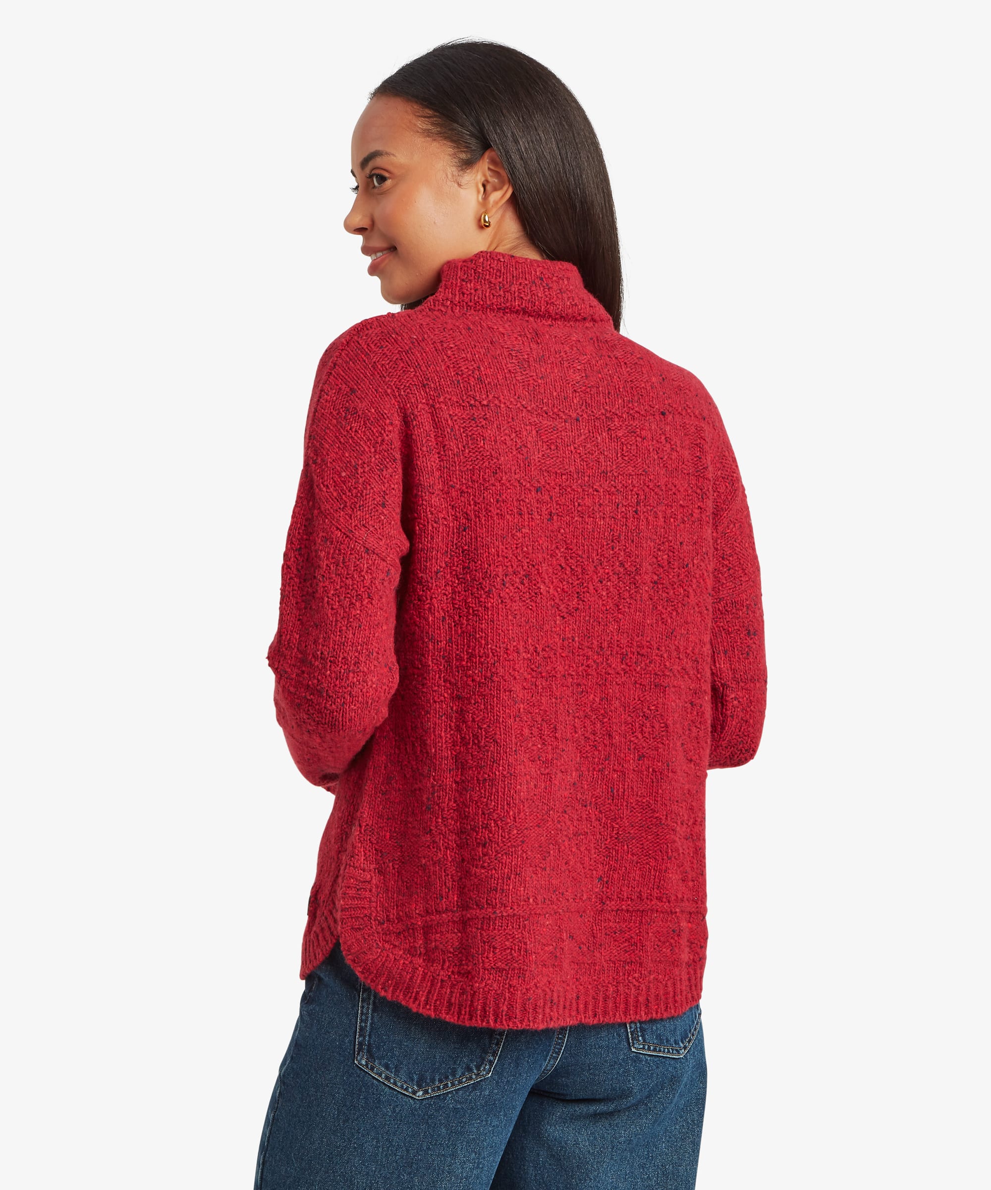 Rear studio view of a woman wearing a red knit sweater paired with blue jeans. The image highlights the clean back design, relaxed fit, and ribbed knit finish.