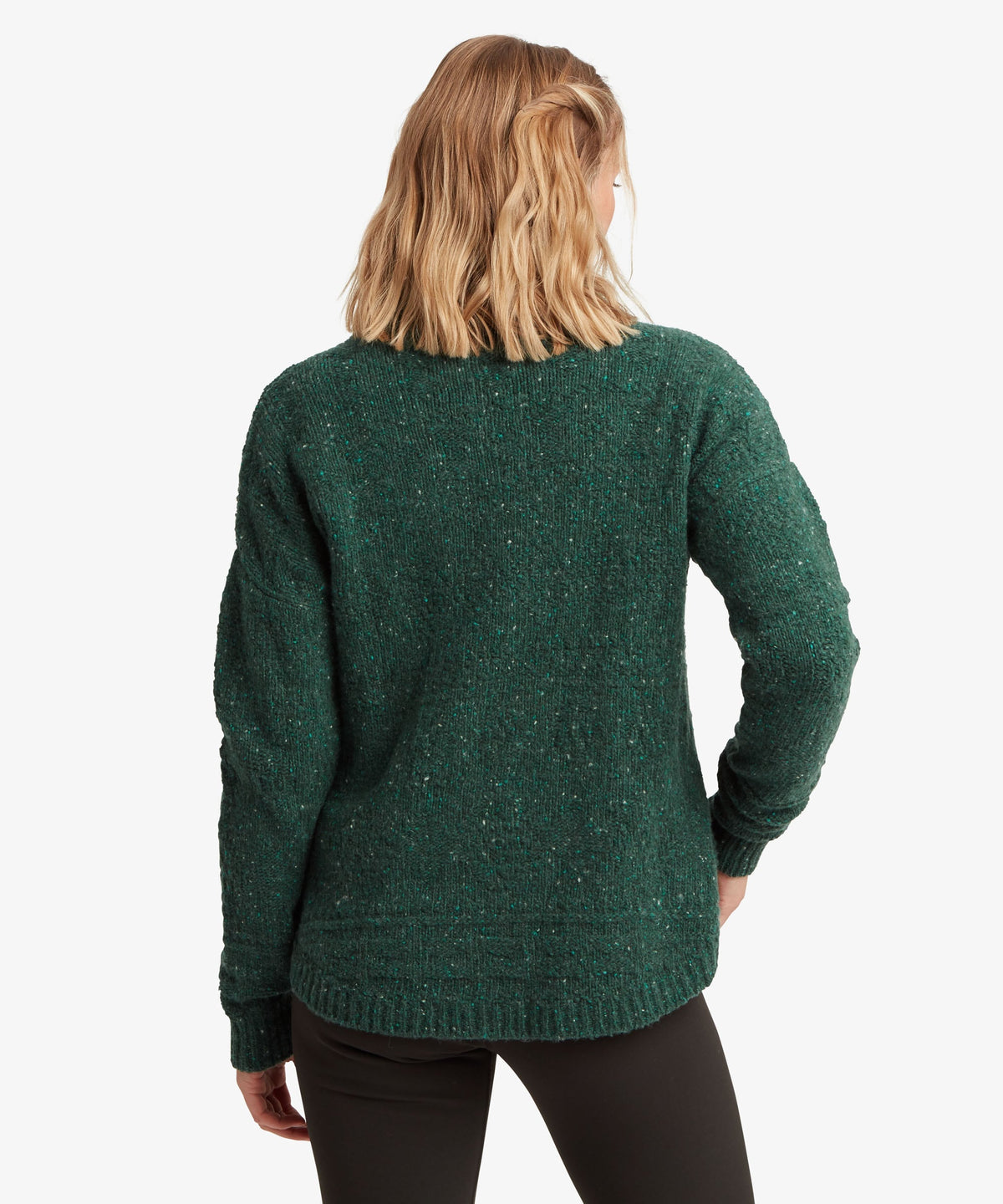 A female model, shown from the back, wearing the green Yuden Sweater by Sherpa Adventure Gear.